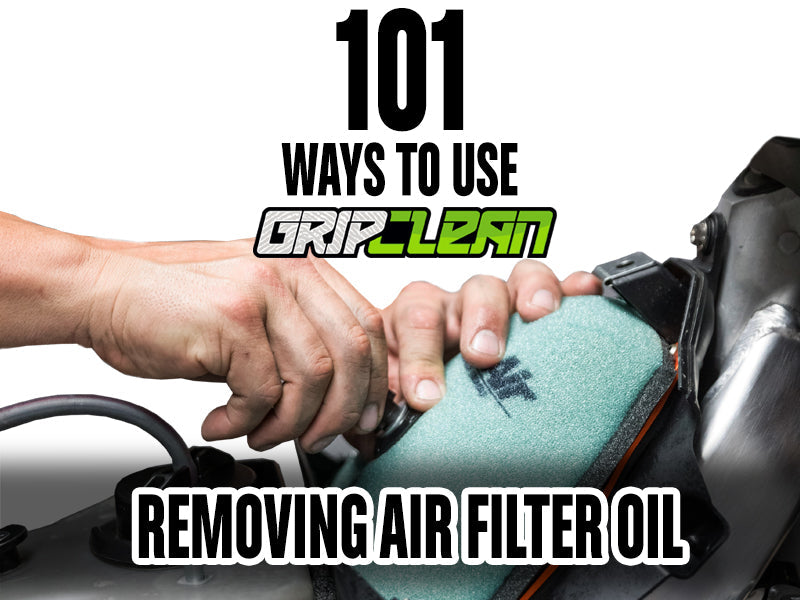 Mechanic demonstrating how to remove air filter oil using Grip Clean heavy-duty hand cleaner in a workshop.