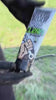 Man washes thick black grease off his hands and forearms outdoors with Grip Clean heavy duty hand soap and a garden hose